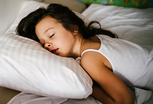493ss_thinkstock_rf_woman_sleeping_with_arms_under_pillow