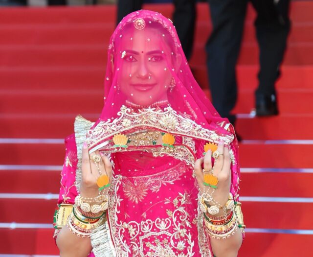gunghat-main Ruchi Gujjar in pink Rajasthani ghunghat-inspired outfit at Cannes Film Festival protesting forced ghughat practices and supporting women empowerment.