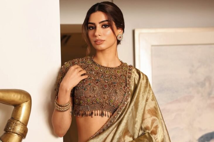 Khushi Kapoor wearing a metallic gold saree with an intricately embellished blouse at Anshula Kapoor's mehendi ceremony.